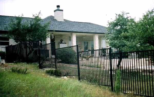 Wrought iron fence stepping down a sloped yard