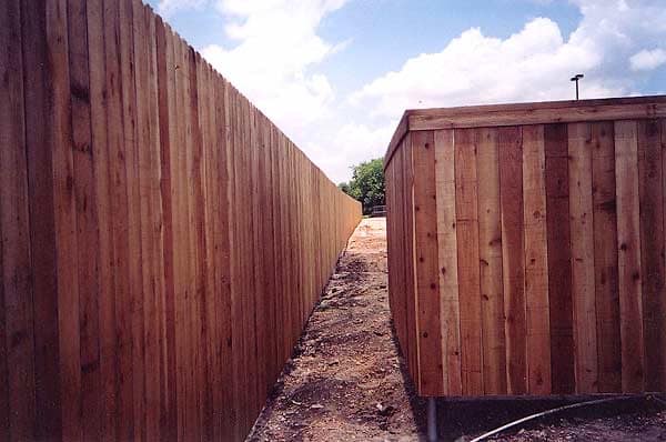 Eight-foot cedar privacy fence behind a commercial building