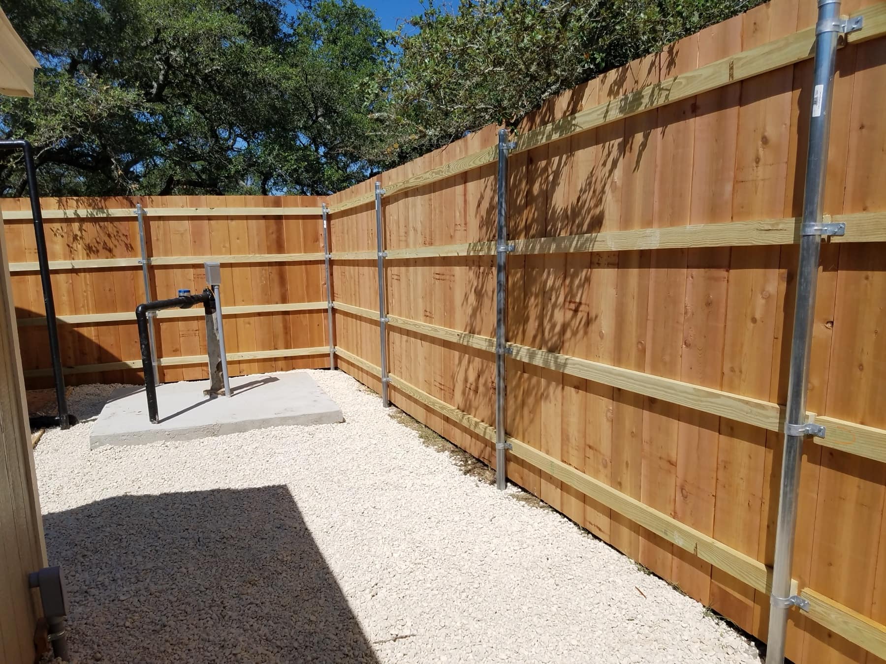 Inside a new cedar privacy fence on galvanized steel posts