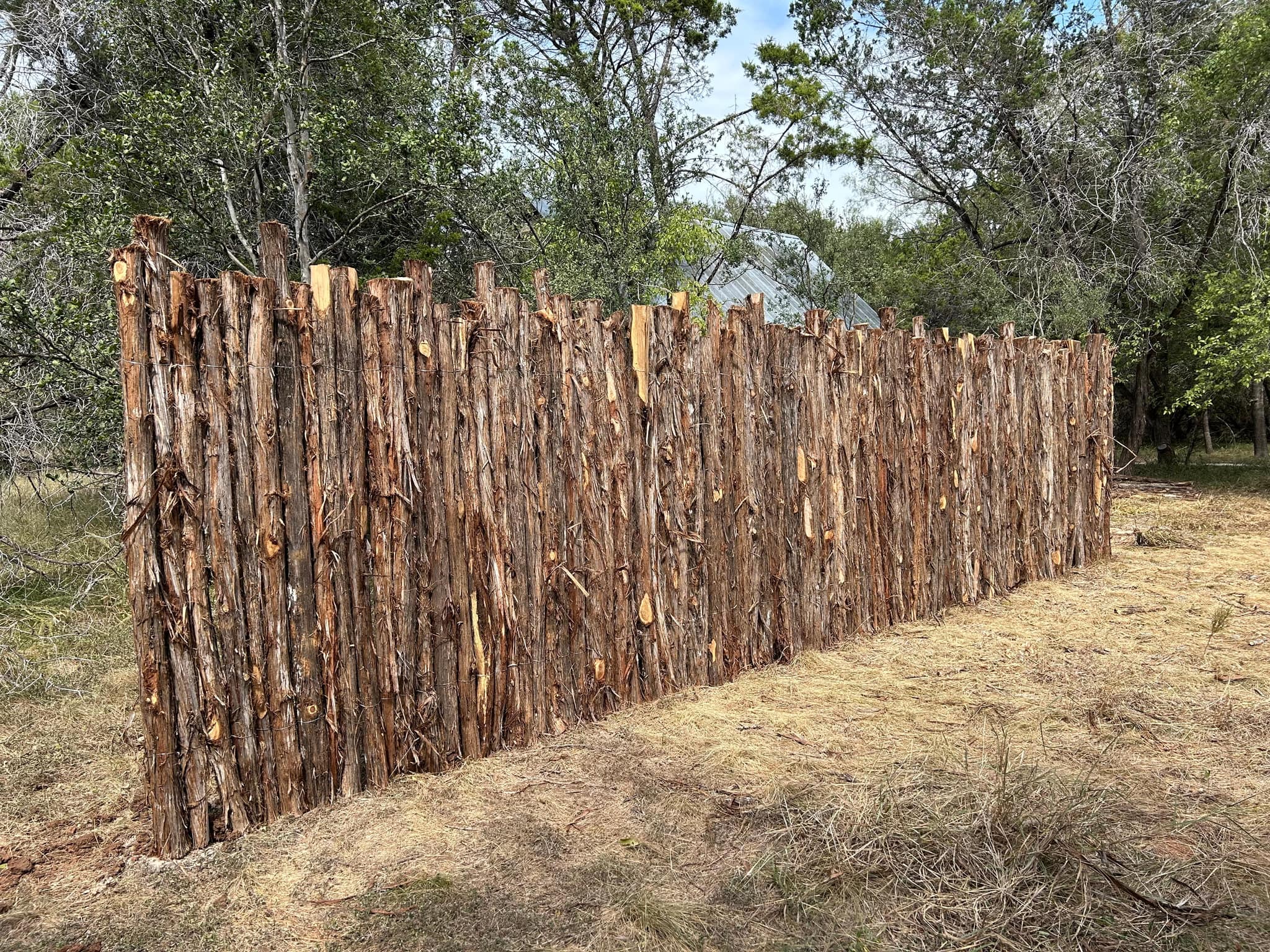 A new run of rough cedar stake coyote fence