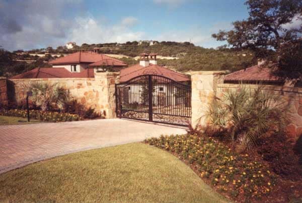 Arched iron estate gates set in a stone wall
