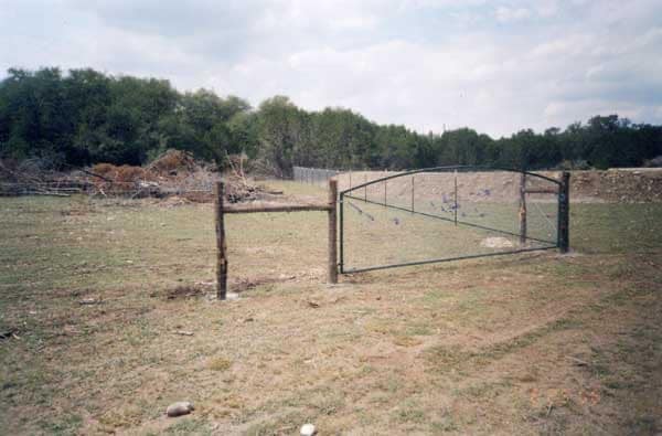 Woven wire field fence around open land