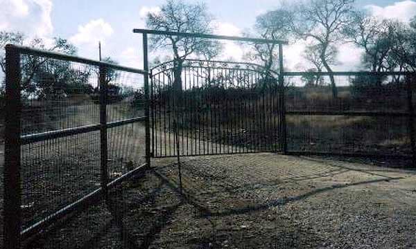 Tall game fence with a matching pipe gate