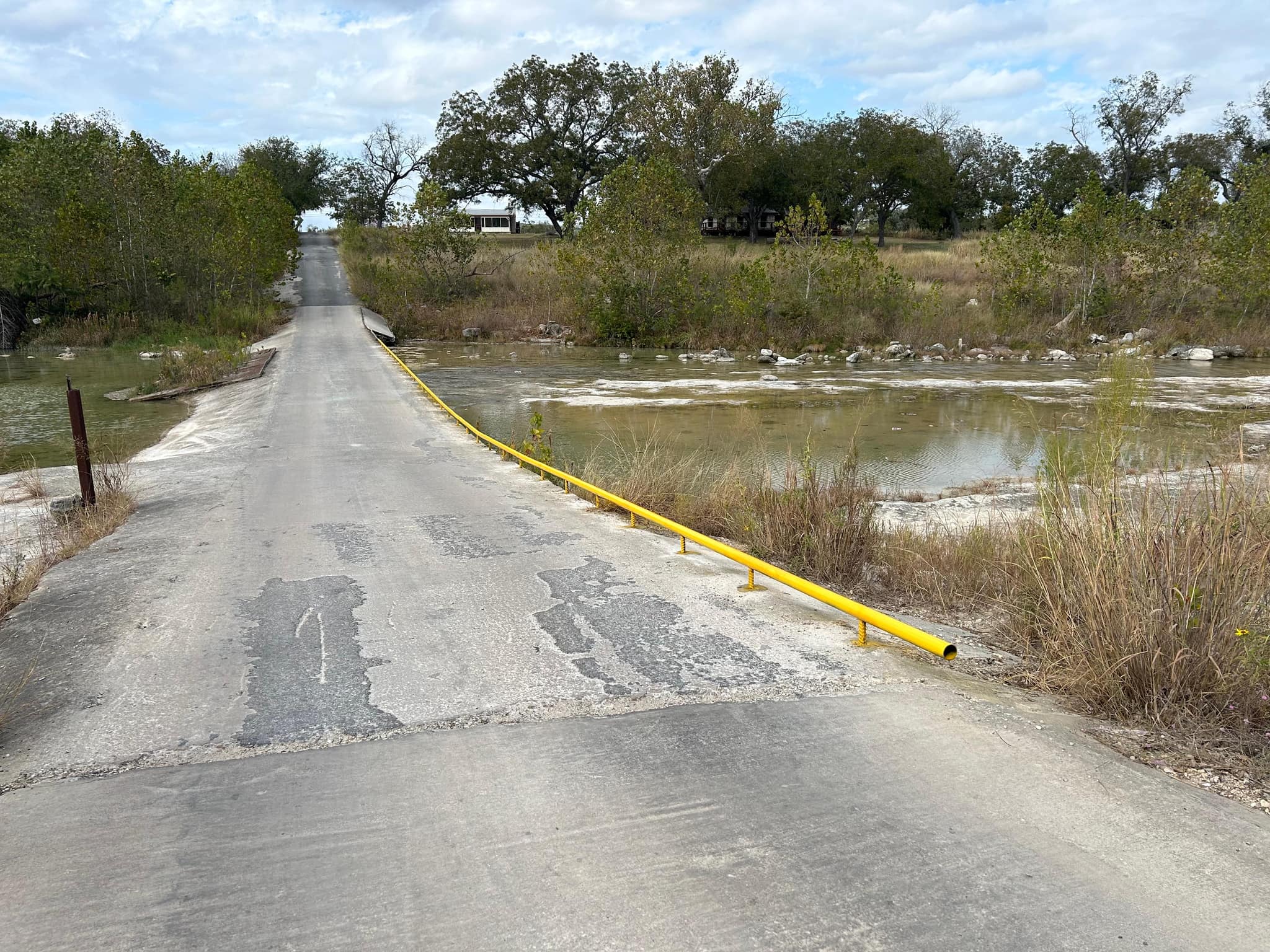 Yellow pipe guard rail along a low-water crossing