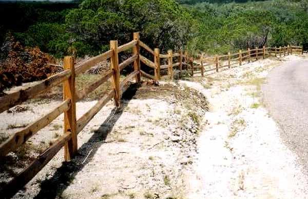 Cedar split rail fence along a caliche drive